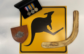 Items on table including sign, medals and Australian emblem